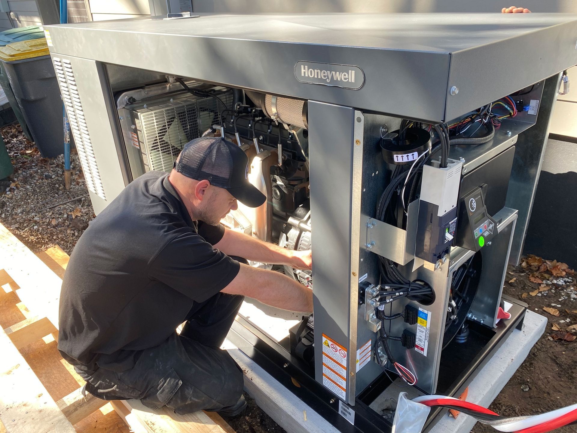 Technician repairing an open commercial refrigerator unit.